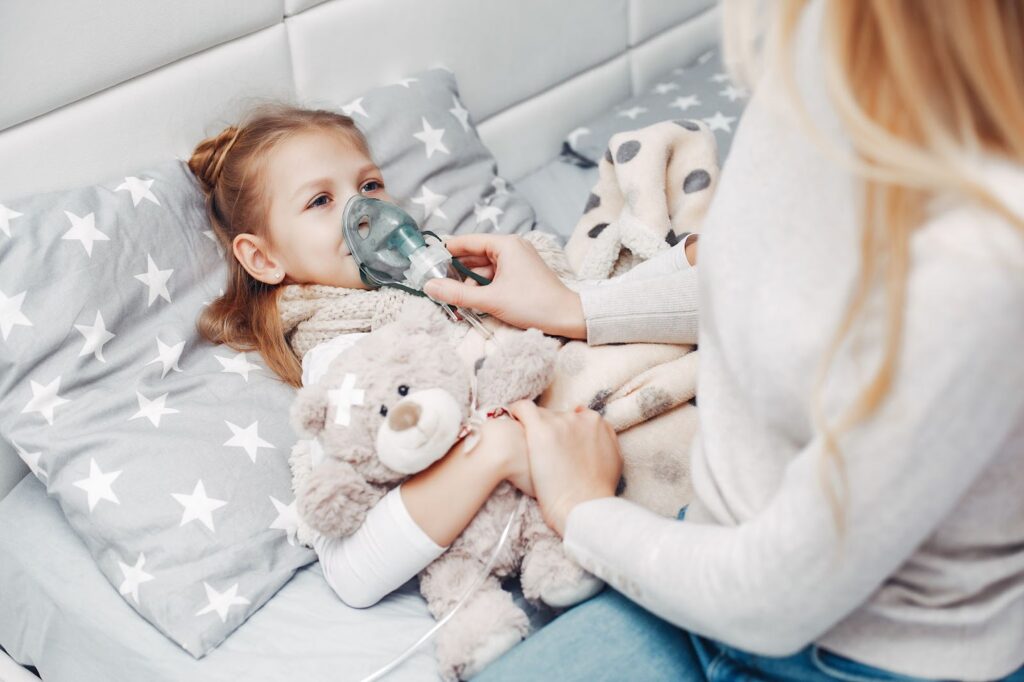 Mother with her daughter using inhaler