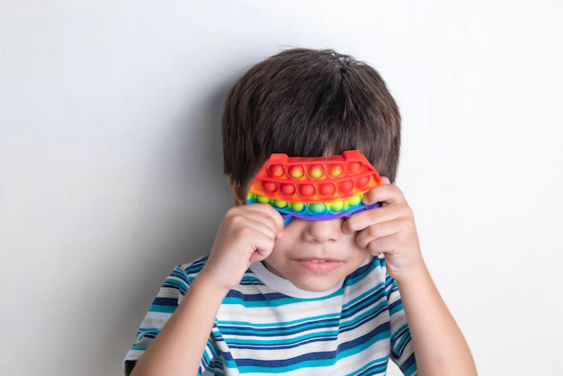 Boy playing with pop-it toy