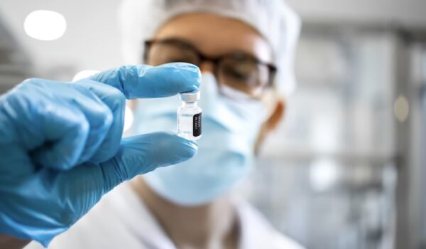 man holding Cancer Prevention Vaccine in his hand